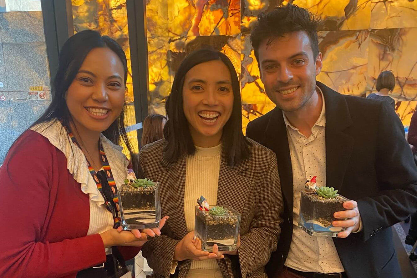 Three people holding their terrariums