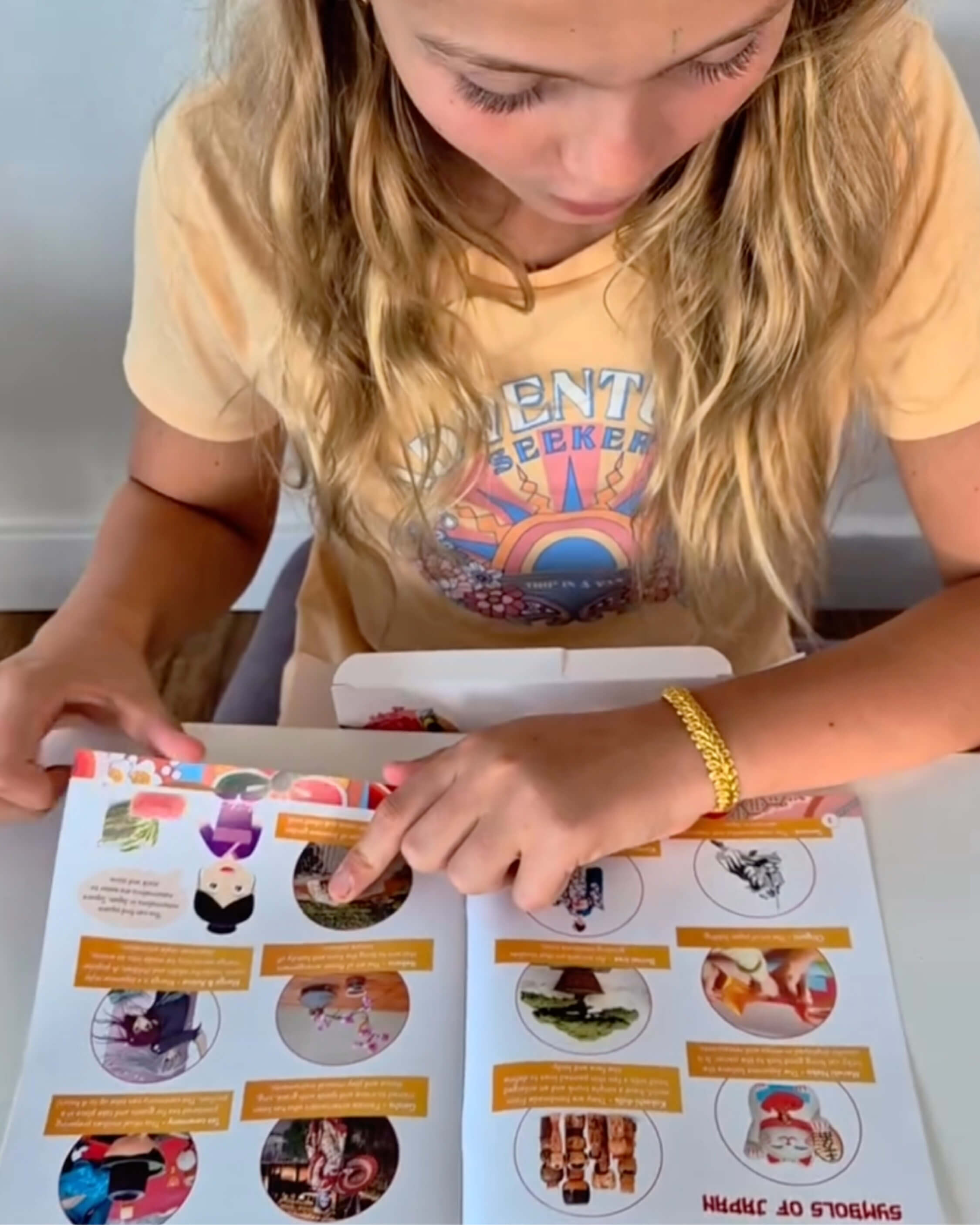 Child interacting with a book on a table