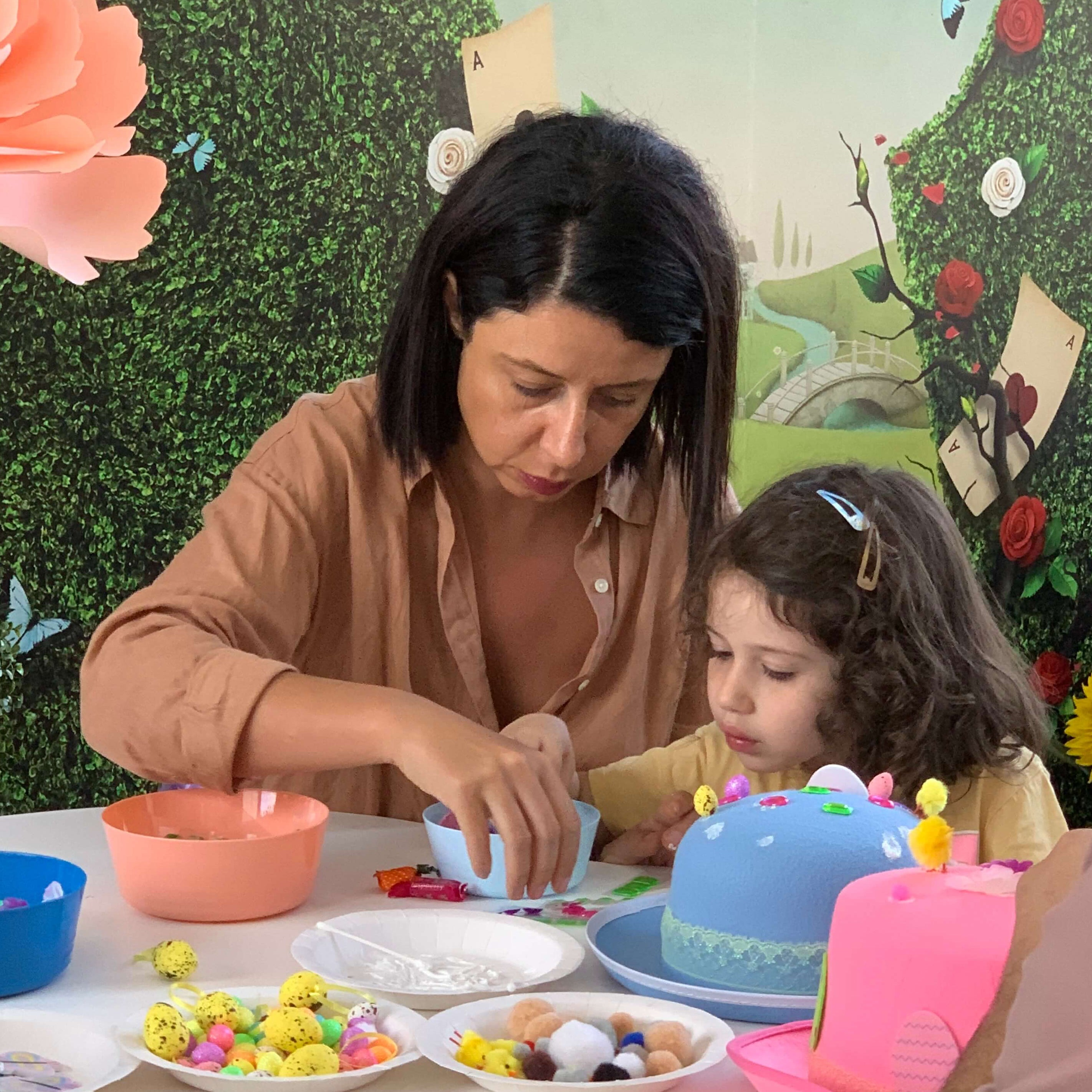 Mother and child decorating Easter hats together