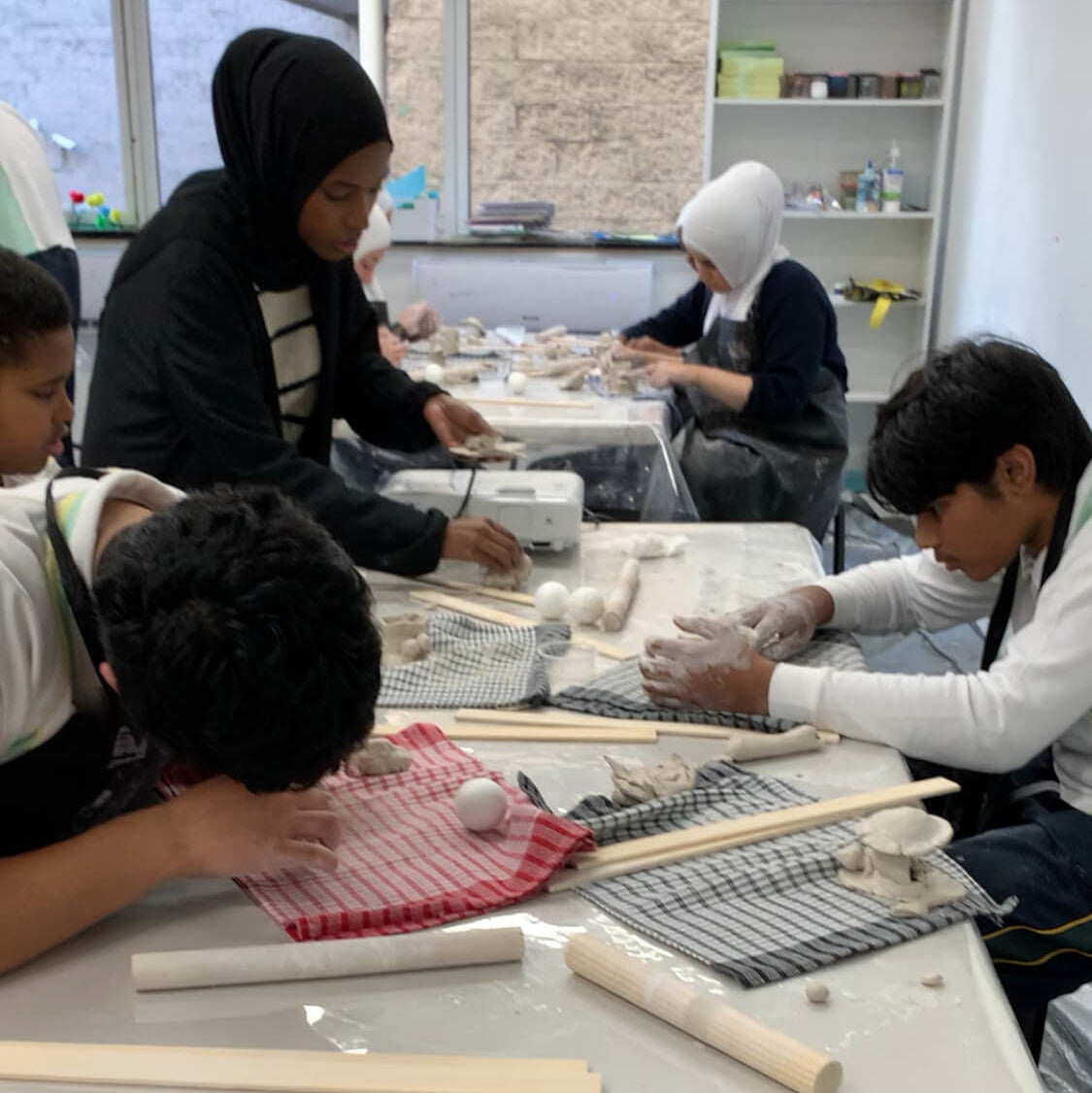 Students making clay sculptures in a classroom