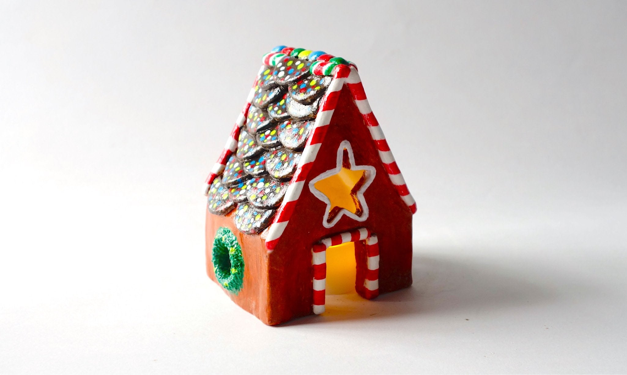 Decorative gingerbread house made from air dry clay.