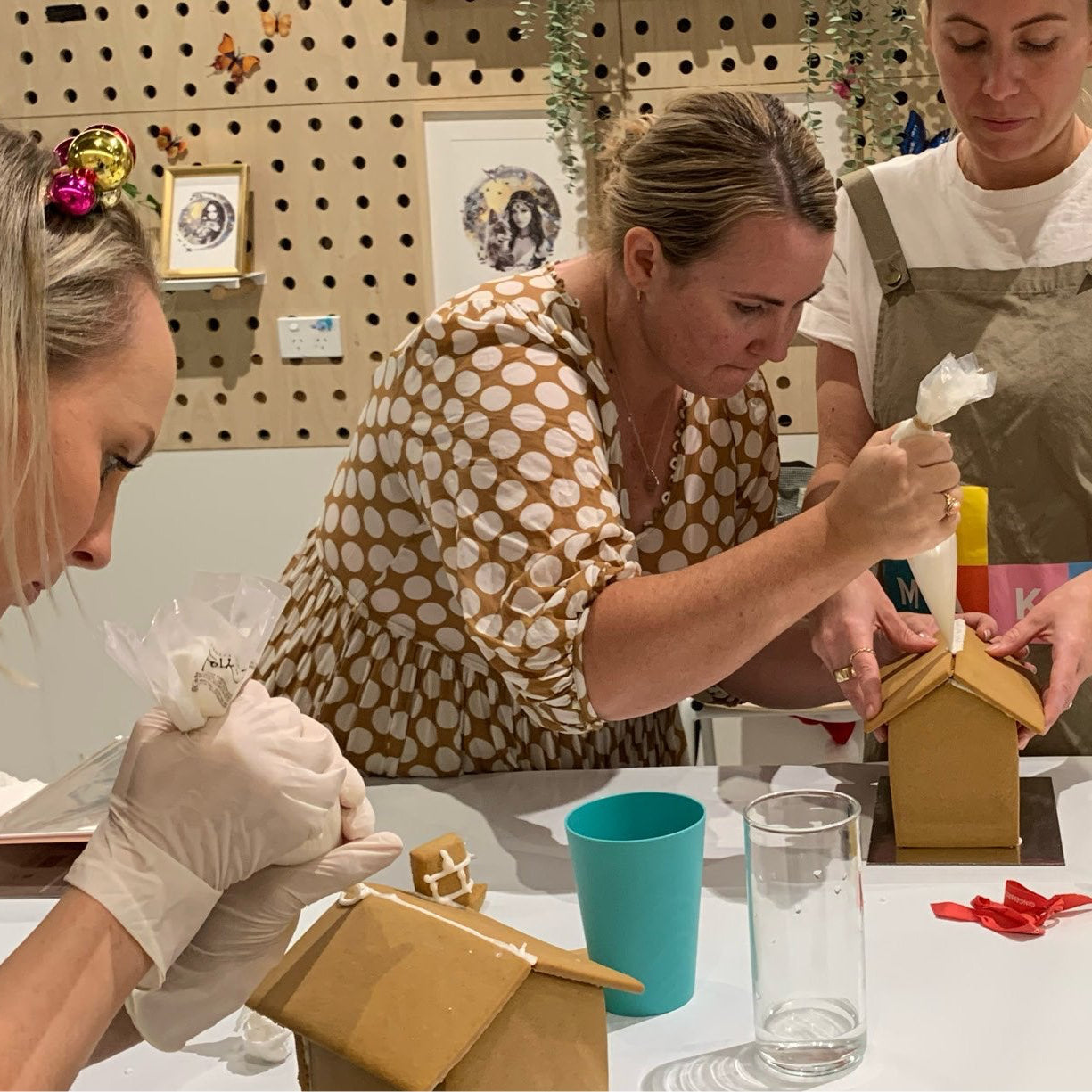 Fun team activity building gingerbread house during workshop.
