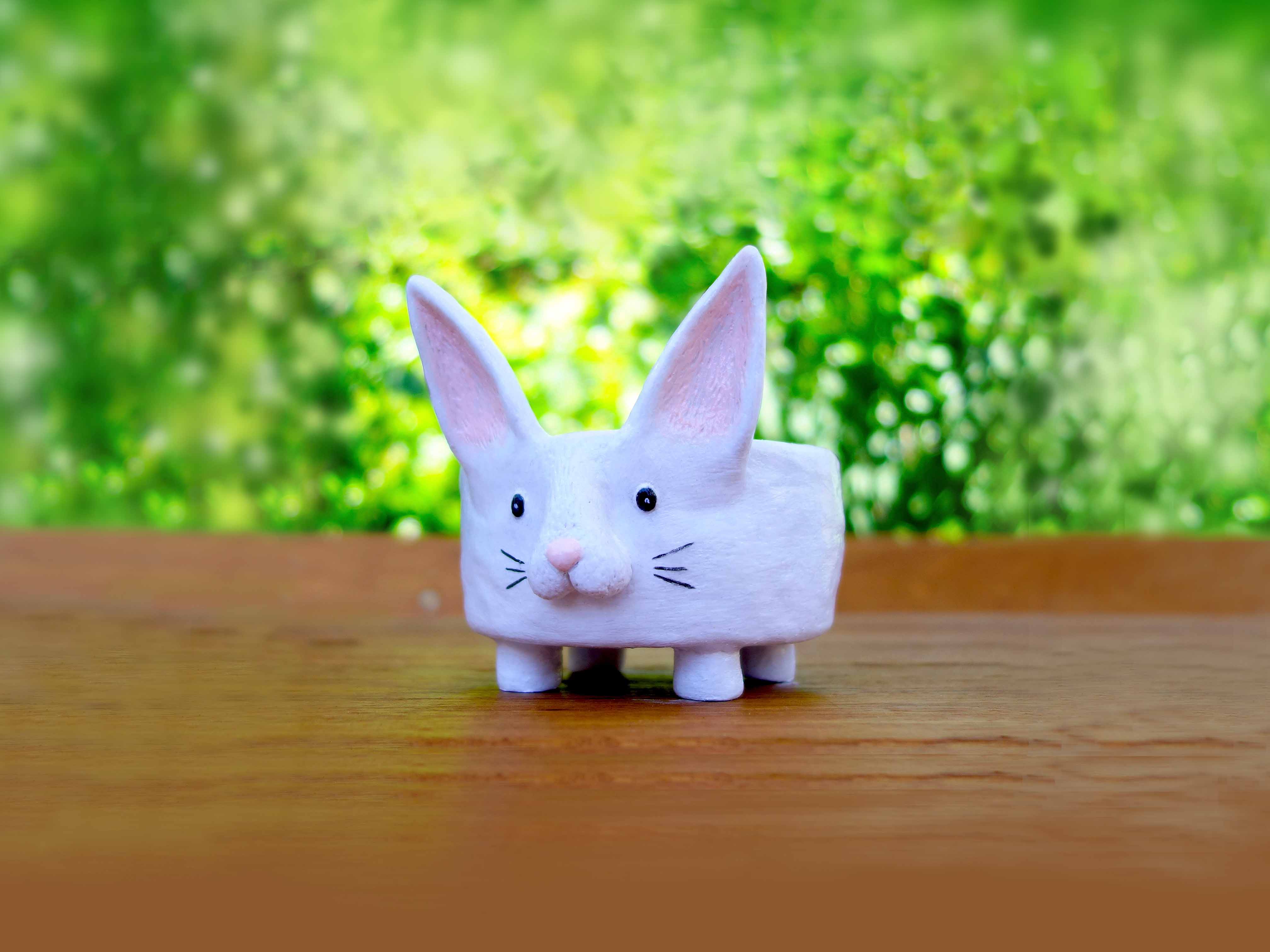White rabbit container from air dry clay on a wooden surface.