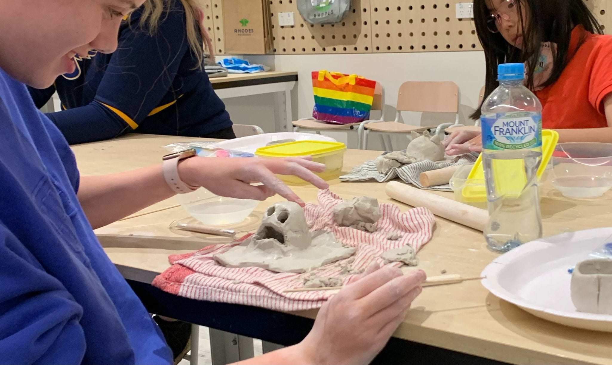 Children making Halloween ghost sculpture from air dry clay.